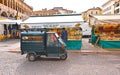 Padova Italy, 30.04.2016. Open market in Piazza Della Frutta Square with old vintage Ape car and colorful old buildings in center Royalty Free Stock Photo