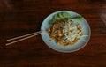 Pad Thai noodles with chicken and cucumbers and bamboo sticks