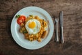 Pad Thai noodles with Omelette and tomato on wooden table Royalty Free Stock Photo