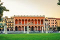 Padua cityscape with Palazzo Loggia Amulea palace neogothic style building and statues near small canal