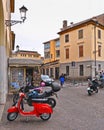 Padua Italy, 30.04.2016. Old red vintage motorcycle Vespa on the street with old buildings and people in downtown city Padova, Ven Royalty Free Stock Photo