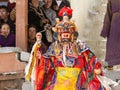 Monk in dharmapala protector deity mask performs a religious costumed mystery Cham dance of Tantric Tibetan Buddhism on Festival