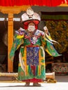 Lama in ritual costume and ornate hat performs a historical mystery Black Hat Dance of Tibetan Buddhism on the Cham Dance Festival