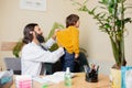 Paediatrician doctor examining a child in comfortabe medical office Royalty Free Stock Photo