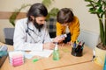 Paediatrician doctor examining a child in comfortabe medical office Royalty Free Stock Photo