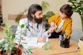 Paediatrician doctor examining a child in comfortabe medical office Royalty Free Stock Photo