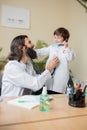 Paediatrician doctor examining a child in comfortabe medical office