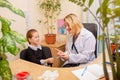 Paediatrician doctor examining a child in comfortabe medical office