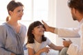 Paediatrician stroking patient girl encourages her before medical examination