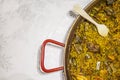 Paella chicken and rabbit dish in its pot served on the table with white tablecloth Royalty Free Stock Photo