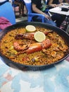 Paella in a large pan freshly served. Royalty Free Stock Photo