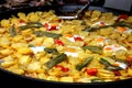 A large pan full of delicious and tasty mix of fried eggs, potatoes and green and red peppers. Royalty Free Stock Photo