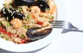 Paella rice dish with mussels, shrimp with fork