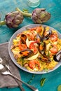 Paella with seafood. Traditional spanish food closeup on wooden table. Royalty Free Stock Photo