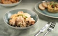 Paella spanish dish. Seafood and chicken risotto on blue plate. Rice, shrimps and chicken. Served on table with fork and Royalty Free Stock Photo