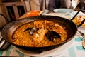 Paella, the traditional dish in Spain. Rustic cast iron skilled filled with seafood paella. Rice with prawns, mussels Royalty Free Stock Photo