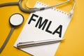 Page with FMLA Family Medical Leave Act on the table with stethoscope, medical concept Royalty Free Stock Photo