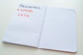 Notebook page, with text `priorities: spend less` Royalty Free Stock Photo