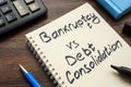 Page of a notepad with an inscription Bankruptcy vs debt consolidation. Royalty Free Stock Photo