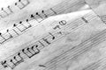 Page of an old musical notebook with hand written notes. Black and white Royalty Free Stock Photo