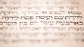 Page of old worn shabby jewish book Torah. Snippet Hebrew Bible text: offer the Passover sacrifice to Jehovah. Closeup