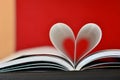 Pages of a book curved into a heart shape