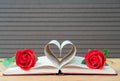 Pages of book curved heart shape and red rose Royalty Free Stock Photo