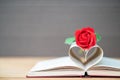 Pages of book curved heart shape and red rose Royalty Free Stock Photo