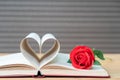 Pages of book curved heart shape and red rose Royalty Free Stock Photo