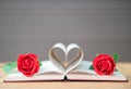 Pages of book curved heart shape and red rose Royalty Free Stock Photo