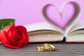 Pages of book curved heart shape with wedding ring Royalty Free Stock Photo