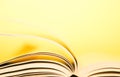 Book pages turning over yellow background. Pages flipping over. Royalty Free Stock Photo