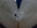 Pages of an open book curved into a heart shape inside with text in spanish Royalty Free Stock Photo