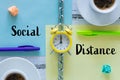 Pages separated by a chain with the words `Social Distance` Clock, office items. The concept of limiting mutual closeness both at