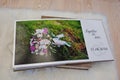 Pages of wedding photobook or wedding album at carpet on wooden