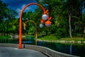 Pond feature in public park and lamp posts.