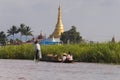 Pagoda at Inle lake and people on boat