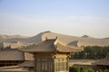 Pagoda rooftops and Singing Sand Mountain, Taklamakan Desert, Du