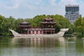 Pagoda on a stone boat with dragon sculptures in Xi`an Tang paradise park.