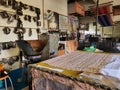 Pahang, Malaysia - 3 NOVEMBER 2021 : Batik block workshop interior with various tools and cloth in stamping process.