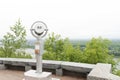 Paid binoculars for exploring the city close-up. Observation deck for exploring the city. Silver telescope with city view