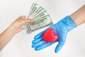 Paid medicine. Patients hand holds out money to the doctor. Costs for the medical insurance. Concept of corruption. Healthcare Royalty Free Stock Photo