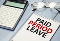 paid period leave words on the white notepad and calculator