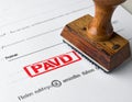 Paid Stamp on Document with Red Ink Marking Payment Confirmation Royalty Free Stock Photo