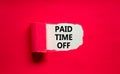 Paid time off symbol. Words `Paid time off` appearing behind torn purple paper. Beautiful purple background. Business, paid time