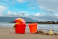 Pail bucket and kids toys on the beach sand Royalty Free Stock Photo