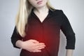 A woman holds on to his stomach. Pain in the abdominal cavity. The concept of diseases of the stomach and digestive system