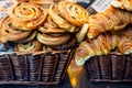 Pain au raisin and croissants in a basket. Side view.