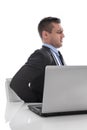 Pain: businessman sitting with backache at desk isolated on whit Royalty Free Stock Photo
