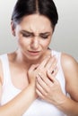 Pain. Close-up of a young woman feels severe chest pain. Close-up of a woman`s body with a hand on her chest. The girl suffers fr